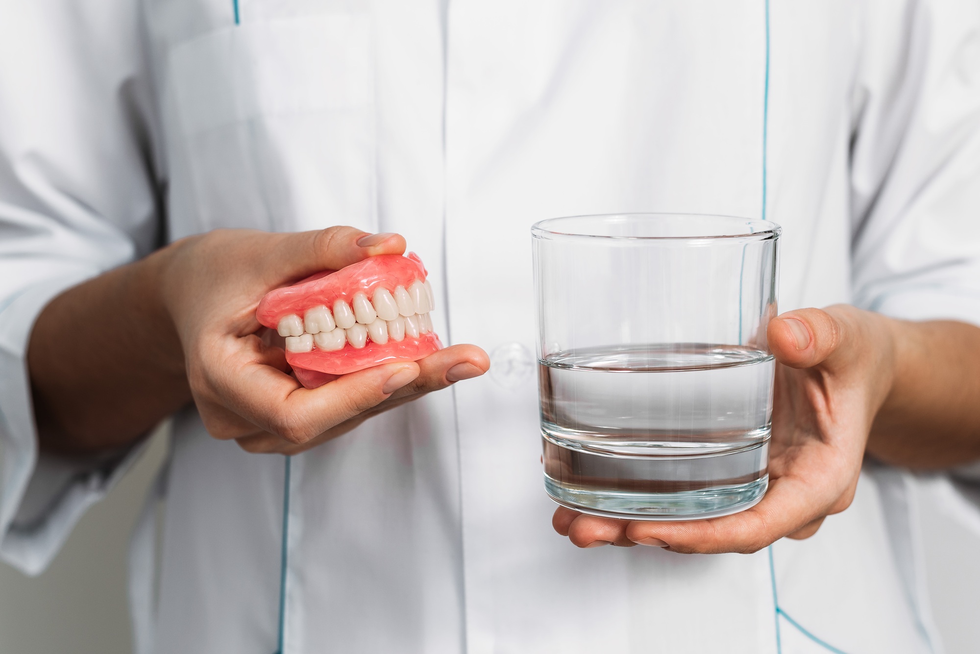 Dental prosthesis care. Full removable plastic denture of the jaws. Two acrylic dentures