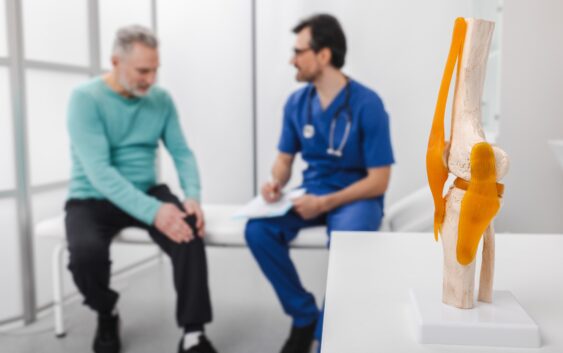 Treatment for knee injuries. Adult man with knee injury during consultation with doctor