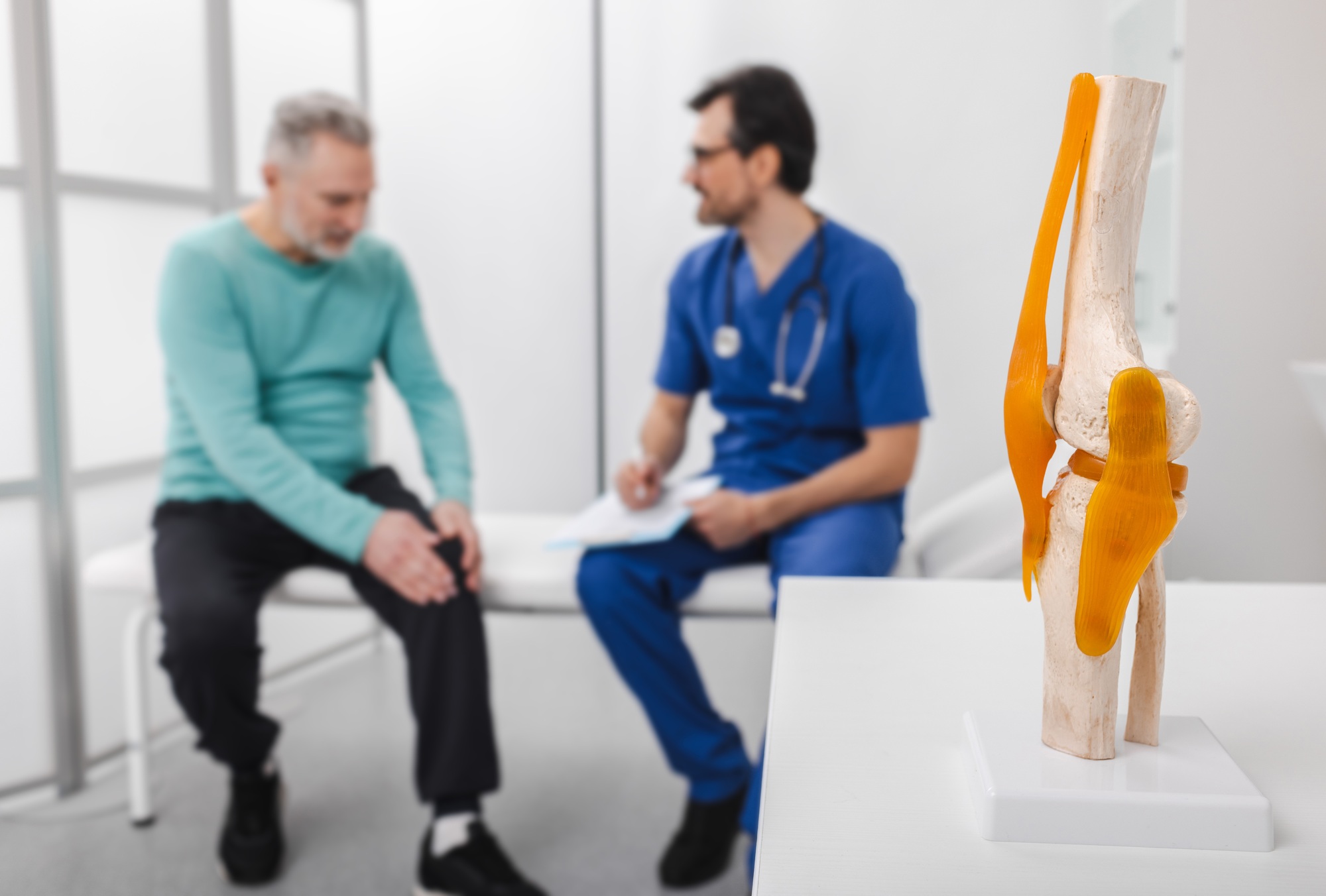 Treatment for knee injuries. Adult man with knee injury during consultation with doctor