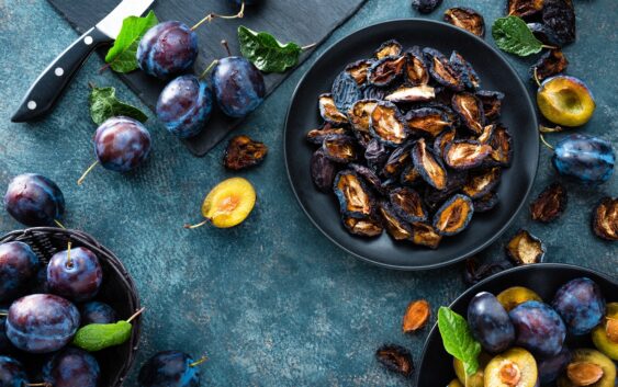 Dried prune and fresh plums with leaves