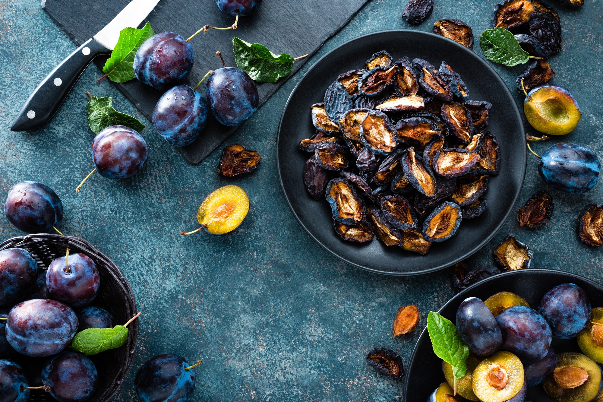 Dried prune and fresh plums with leaves